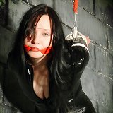 Girl in black latex bound